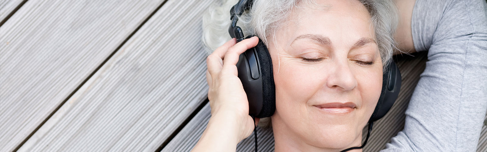 a woman holding headphones against her head