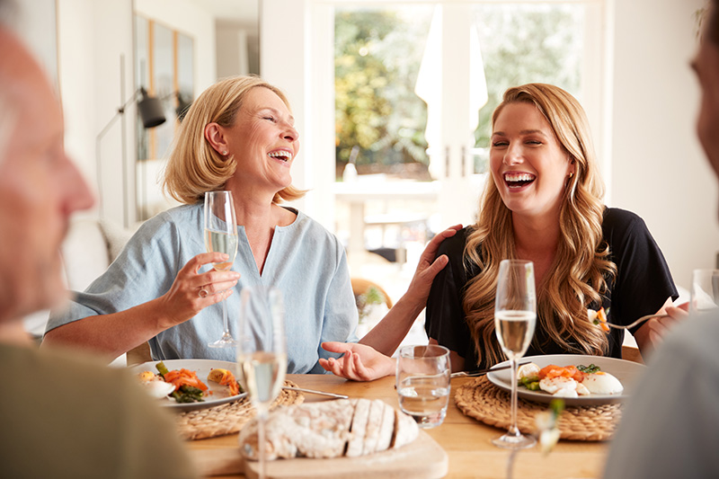 Family With Senior Parents And Adult Offspring Eating Brunch Around Table At Home Together Family With Senior Parents And Adult Offspring Eating Brunch Around Table At Home Together