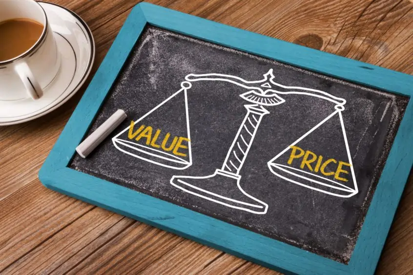 Scales drawn on a small chalkboard with the words "VALUE" and "PRICE" on each side.
