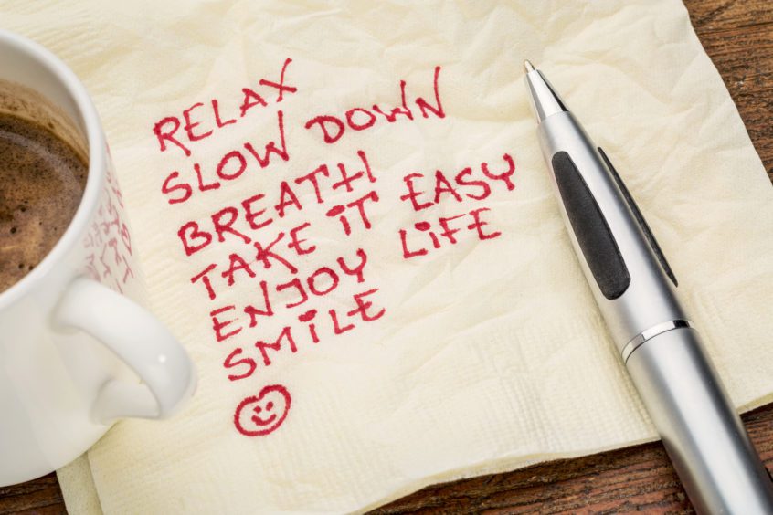 "Relax, slow down, breath, take it easy, enjoy life, smile" written in red ink on a napkin.