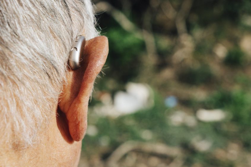 senior man wearing a hearing aid