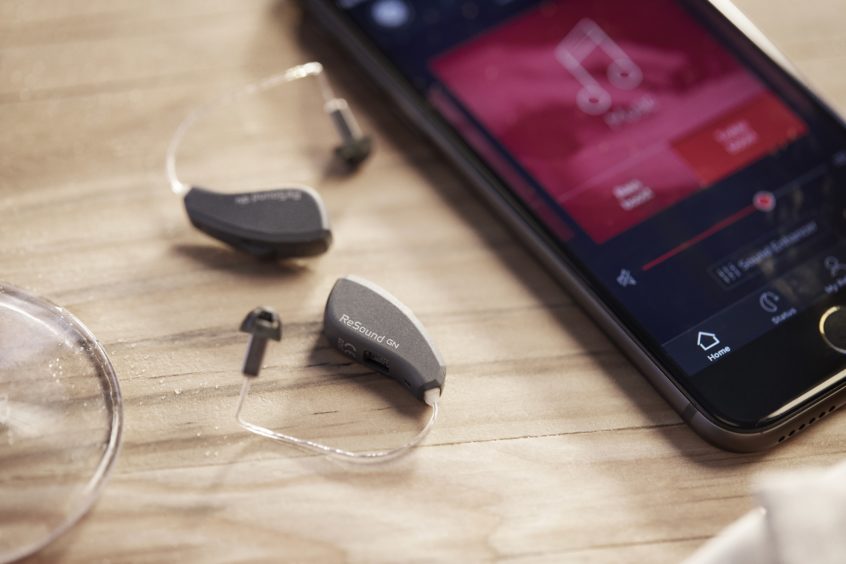 ReSound LiNX Quattro hearing aids next to smarthphone