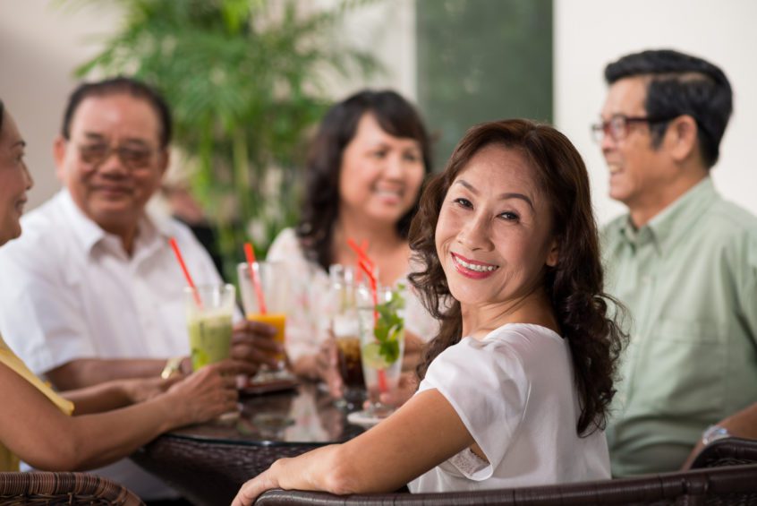 women and men sitting at a cocktail party