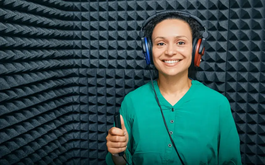An Associated Audiologists' patient in a sound-proof booth, partaking in a hearing exam.