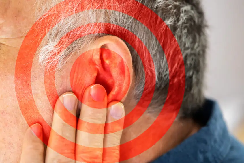 Man covering the opening of his ear with his hand, with a graphical overlay of a target bullseye representing focus or attention to hearing.