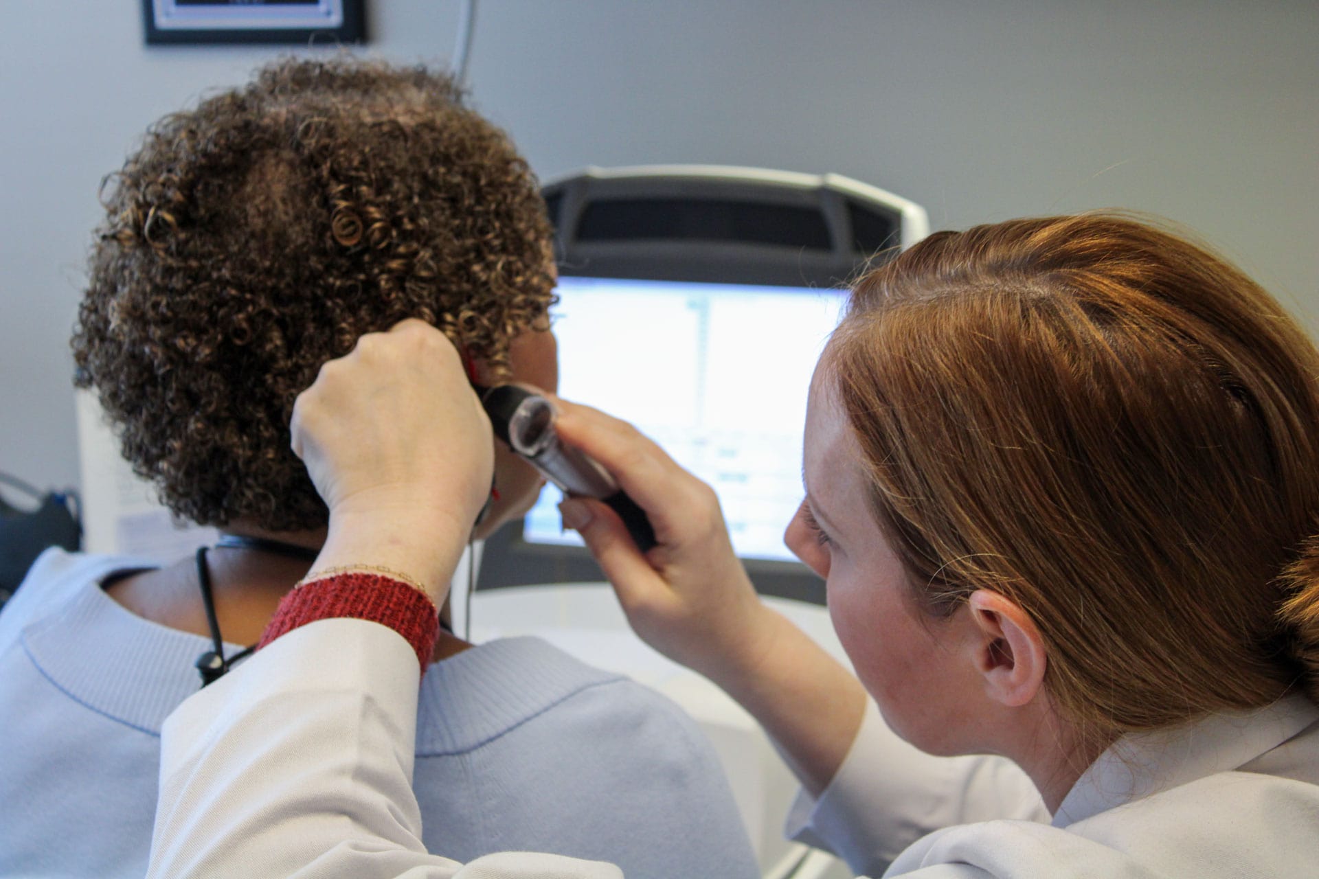 An Associated Audiologists hearing specialist performing a specialized hearing evaluation on a patient.