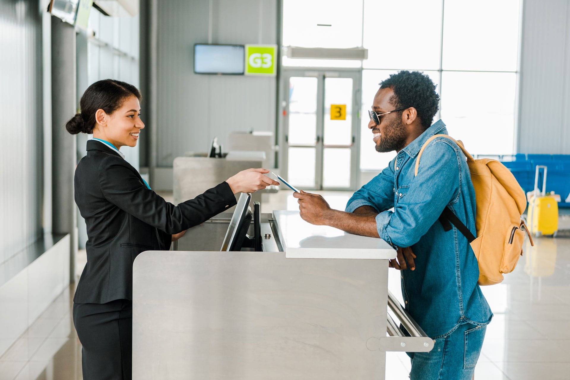 A traveler sharing passport information with an airline agent at Gate G3.