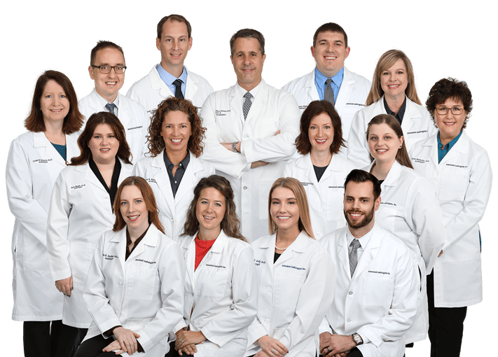 Group_6-24-min A group of hearing specialists with Associated Audiologists grouped together in lab uniform.
