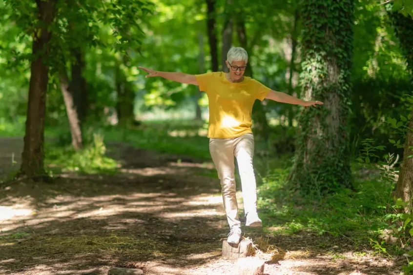 woman balancing on one leg, Associated Audiologists Overland Park