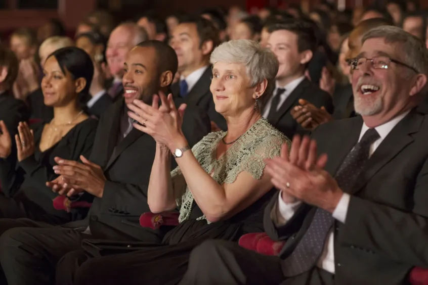 People with hearing loss clapping at a live performance, Associated Audiologists Kansas City